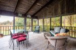 Screened-in porch with plenty of seating 